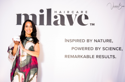 Milave founder Ivanny Soto in front of a promotional banner